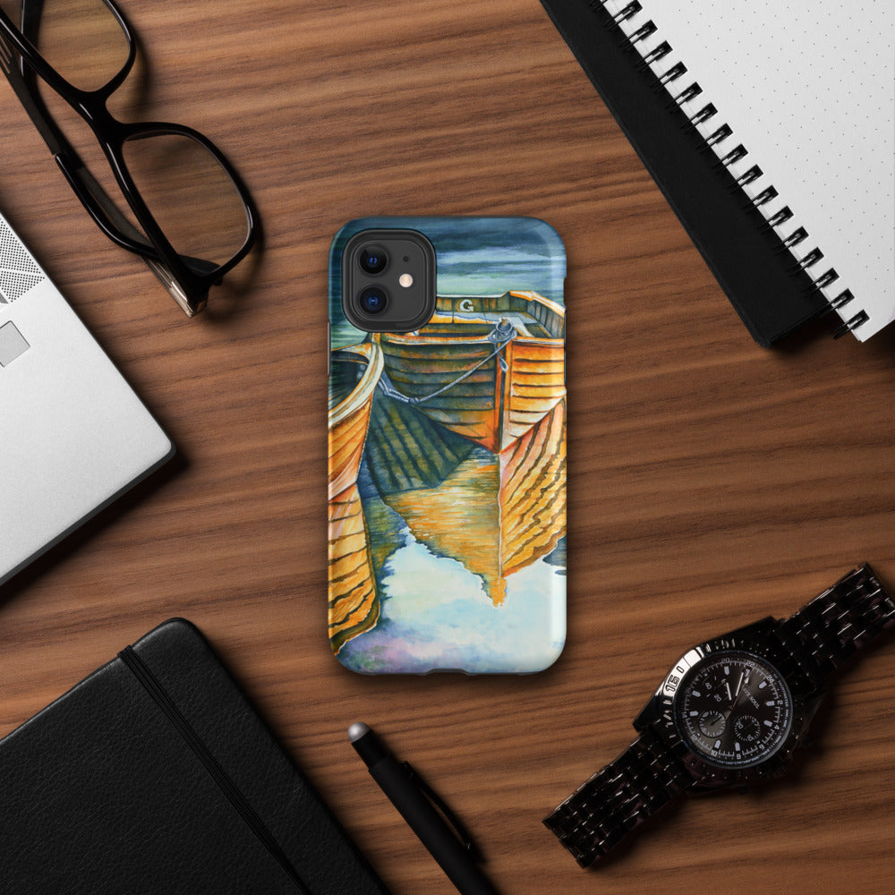 Phone case with a dock design on a wooden desk with a laptop, glasses, and watch.