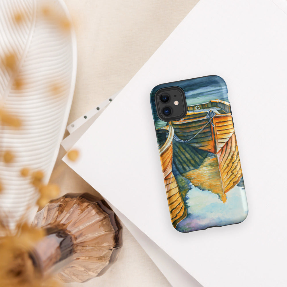 Phone case with a colorful boat design on a white surface