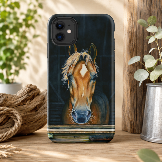 A phone case featuring a detailed portrait print of a brown horse with a white blaze, shown standing on a rustic wooden surface with plants and rope in the background.